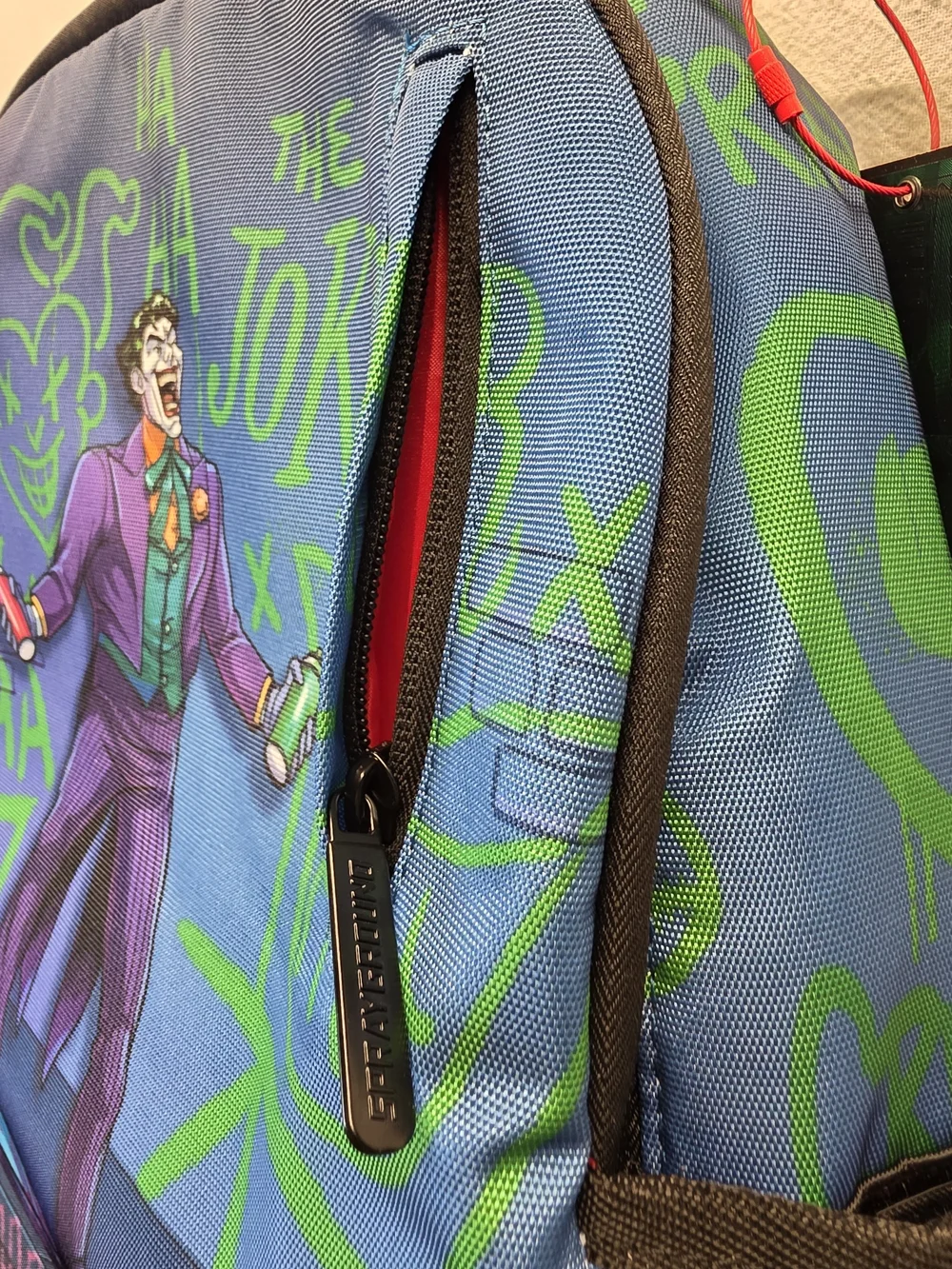 Sprayground DC Joker No Rules Backpack featuring a vibrant, graffiti-styled Bag